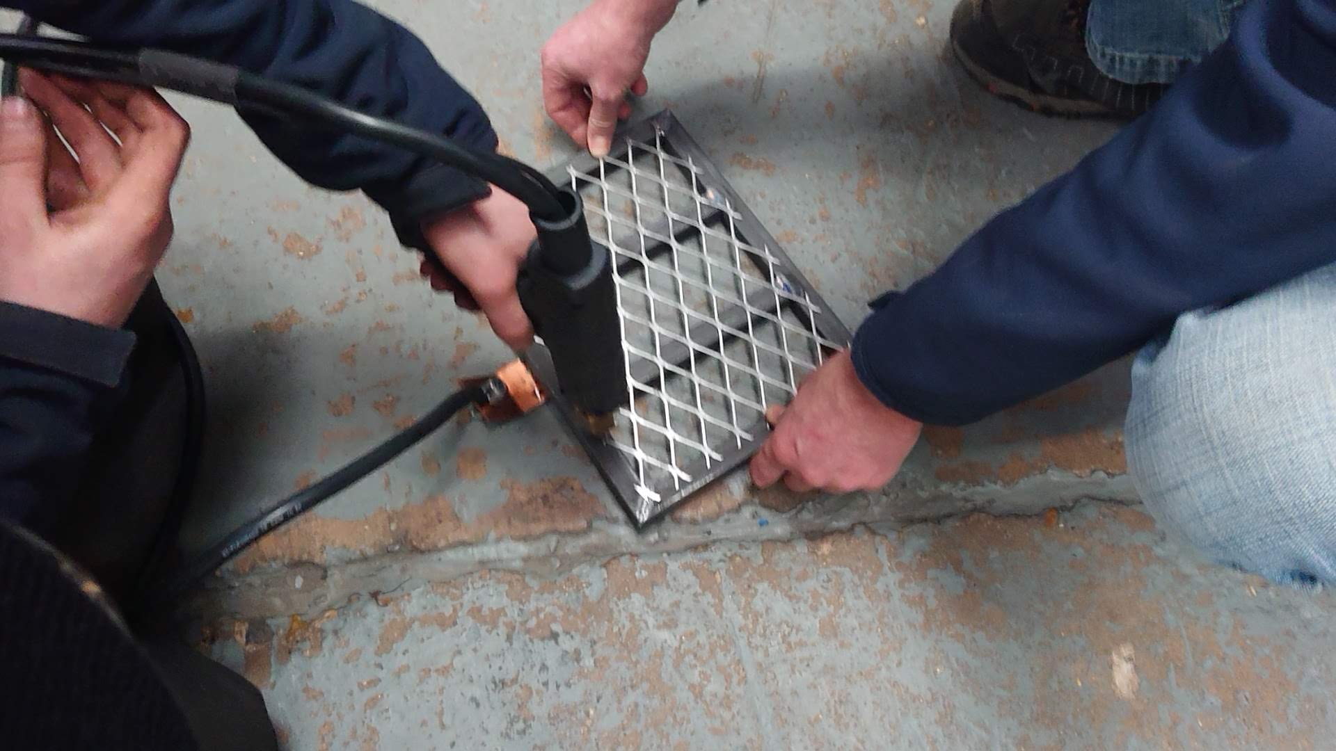 Poke welding of steel mesh grate