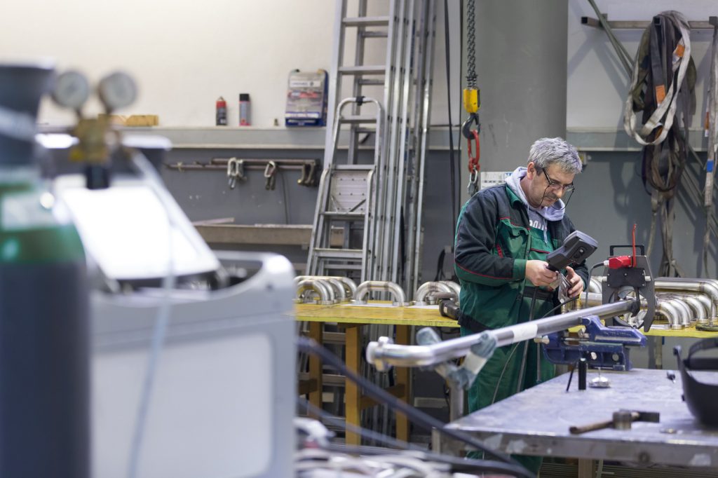 Orbital welding operator setting up orbital welding system