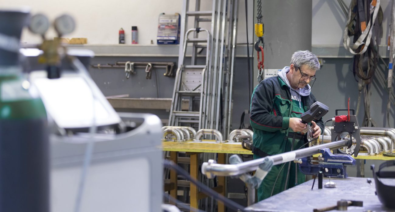 Orbital welding operator setting up orbital welding system