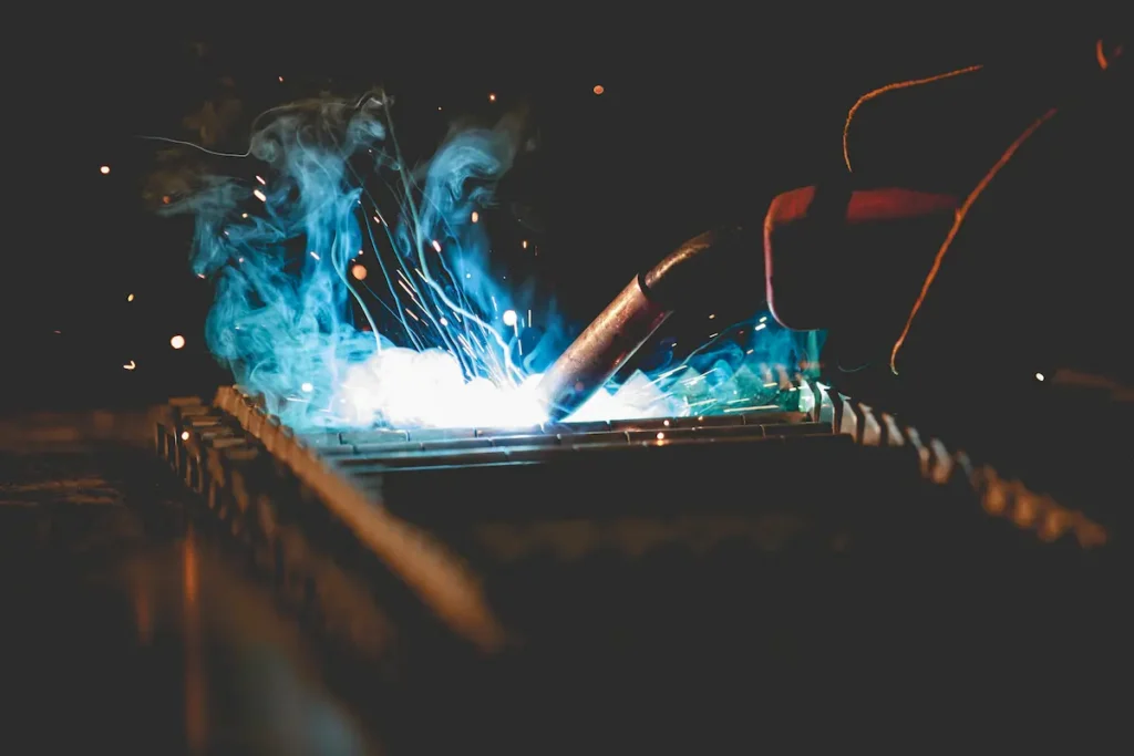 mig welding torch with welding fume close up